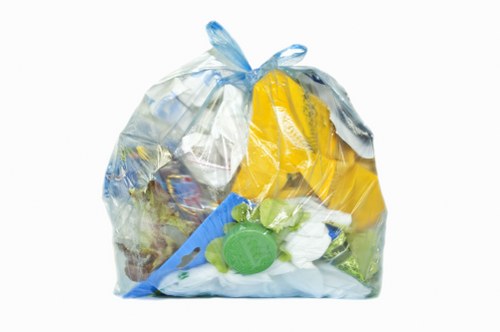 Skip hire vehicles and yellow skip on a Bethnal Green street